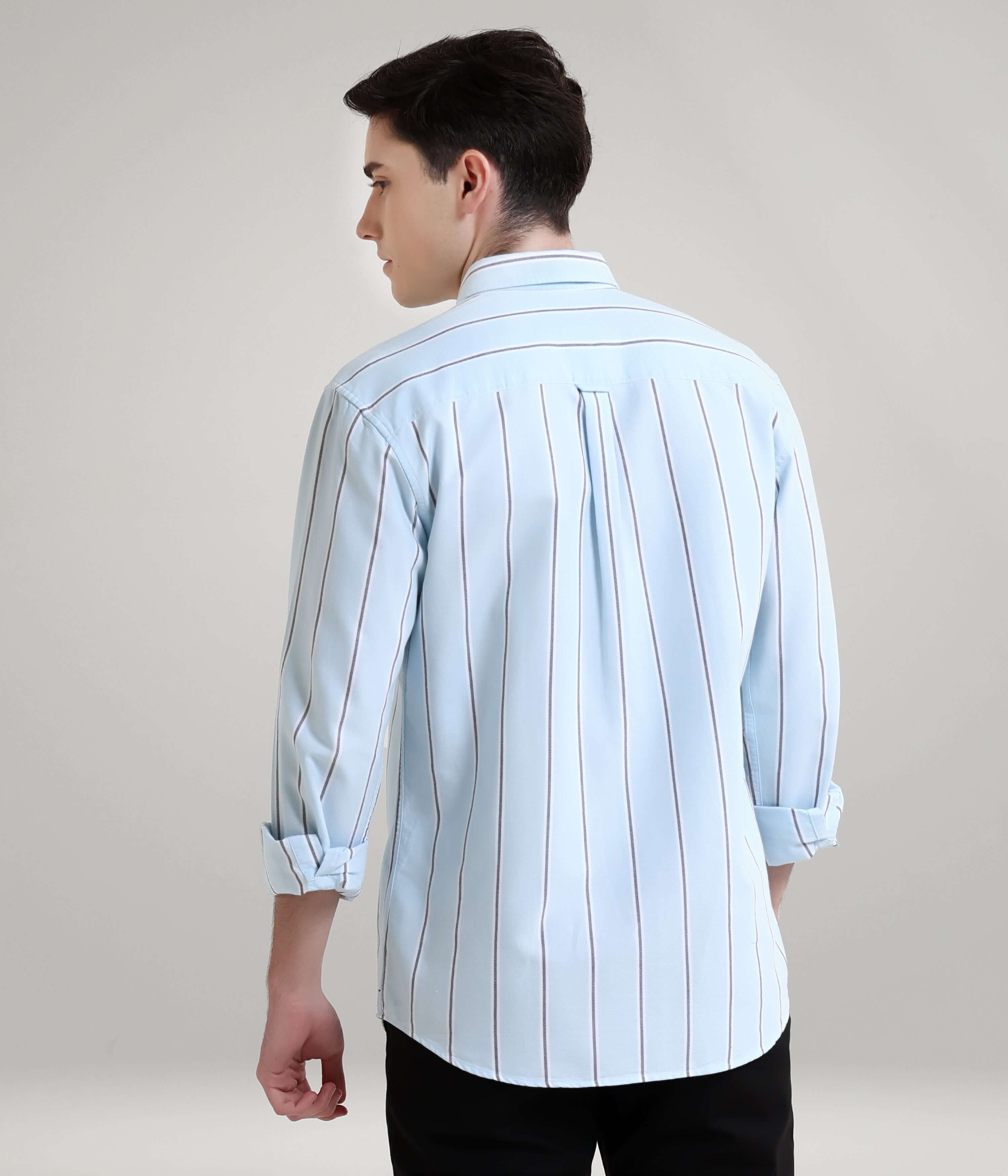 Man wearing a premium stripe shirt with concealed buttons in blue, showcasing anti-stain and anti-odor knitted menswear functionality.