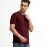 Man wearing a burgundy round-neck Turms T-shirt with tailored fit, stain-proof, odor-resistant, and anti-microbial fabric.