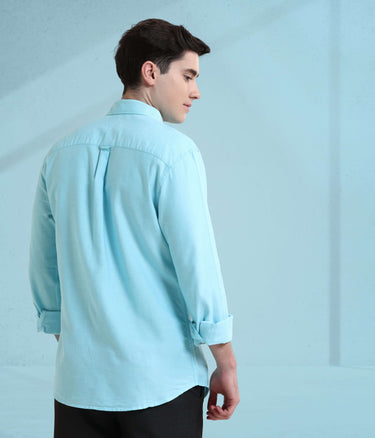 Man wearing a turquoise Oxford shirt, showcasing style and functionality with premium quality and durability.