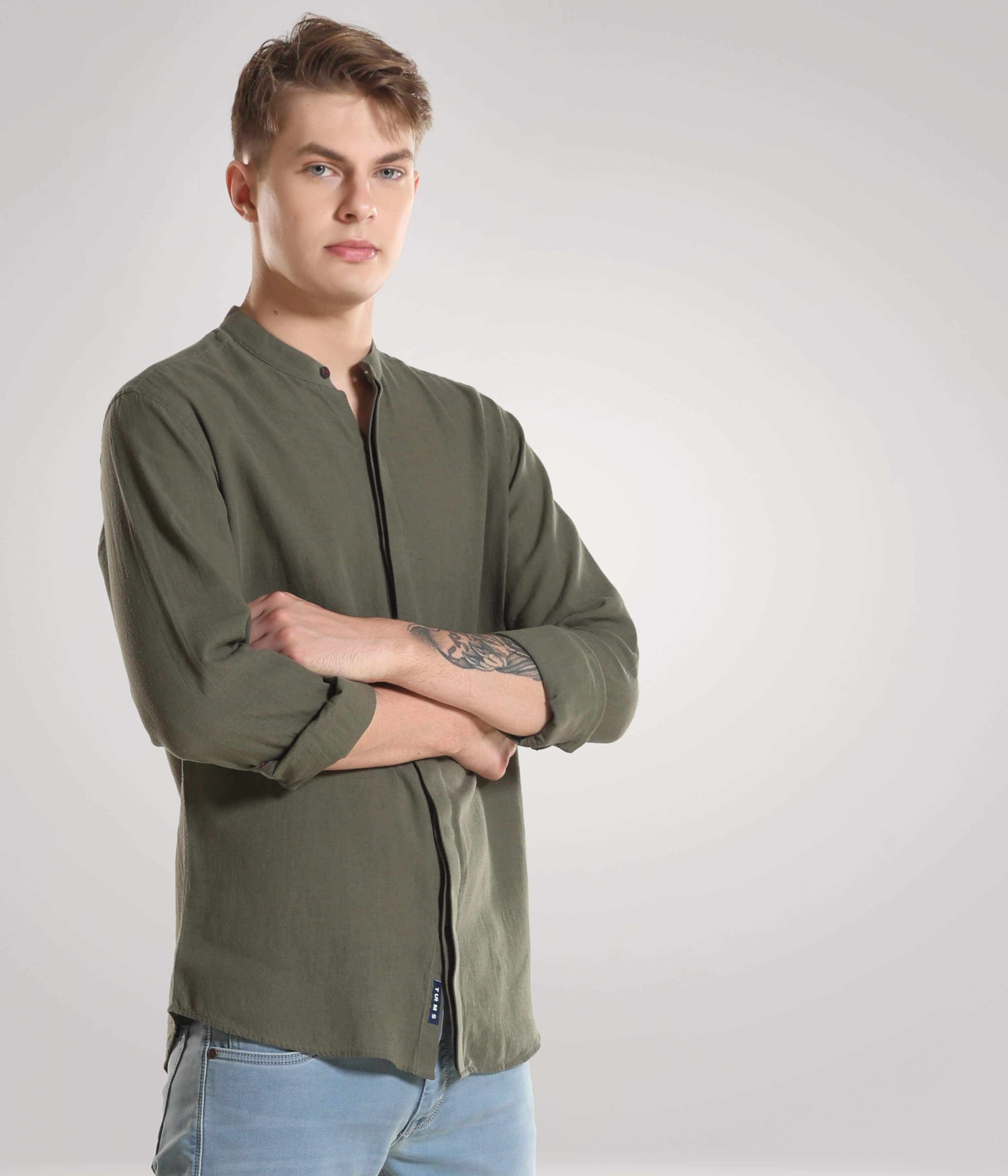 Man wearing a Lichen Green Cotton/Linen Turms shirt with mandarin collar, showcasing premium clothing with CoolTech, antistain, and anti-odour features