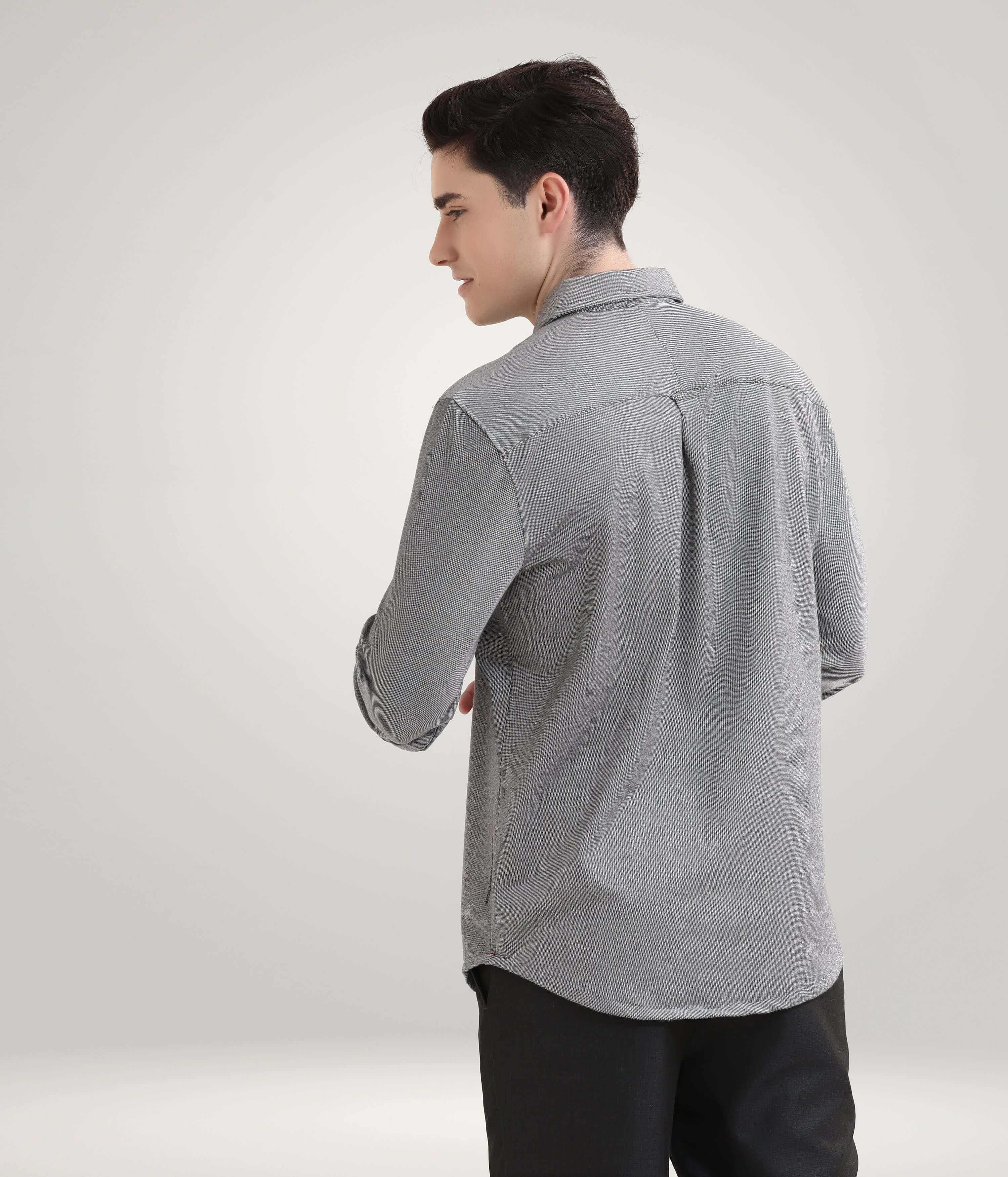 Man wearing Stormy Charcoal Knitted Turms Stretchable Shirt, premium menswear with anti-stain and anti-odour features.