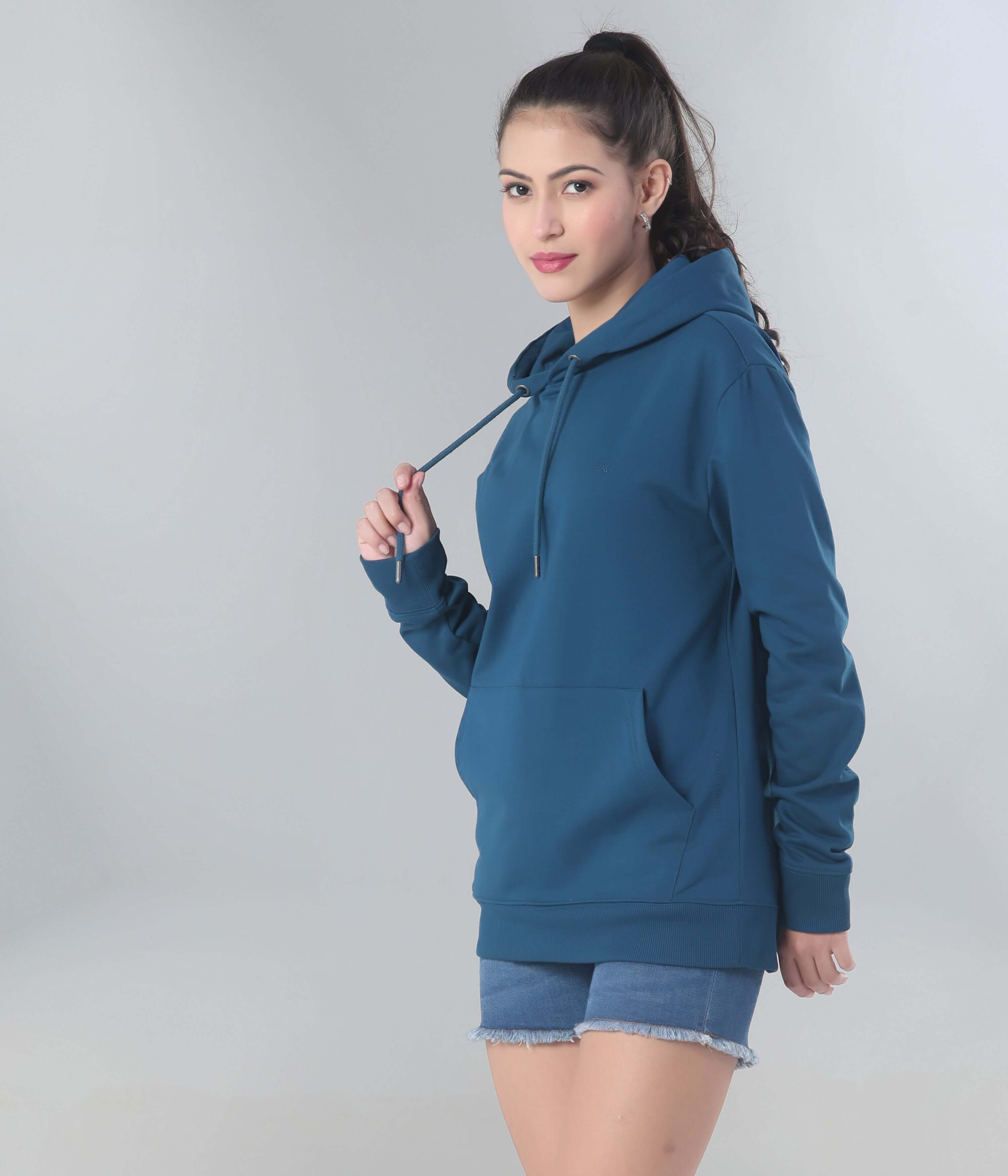 Woman modeling a blue hoodie from Turms Intelligent Apparel, showcasing style, comfort, and functionality.