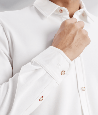 Close-up of a man wearing a White Willow shirt, showcasing its premium fabric and stylish button details.