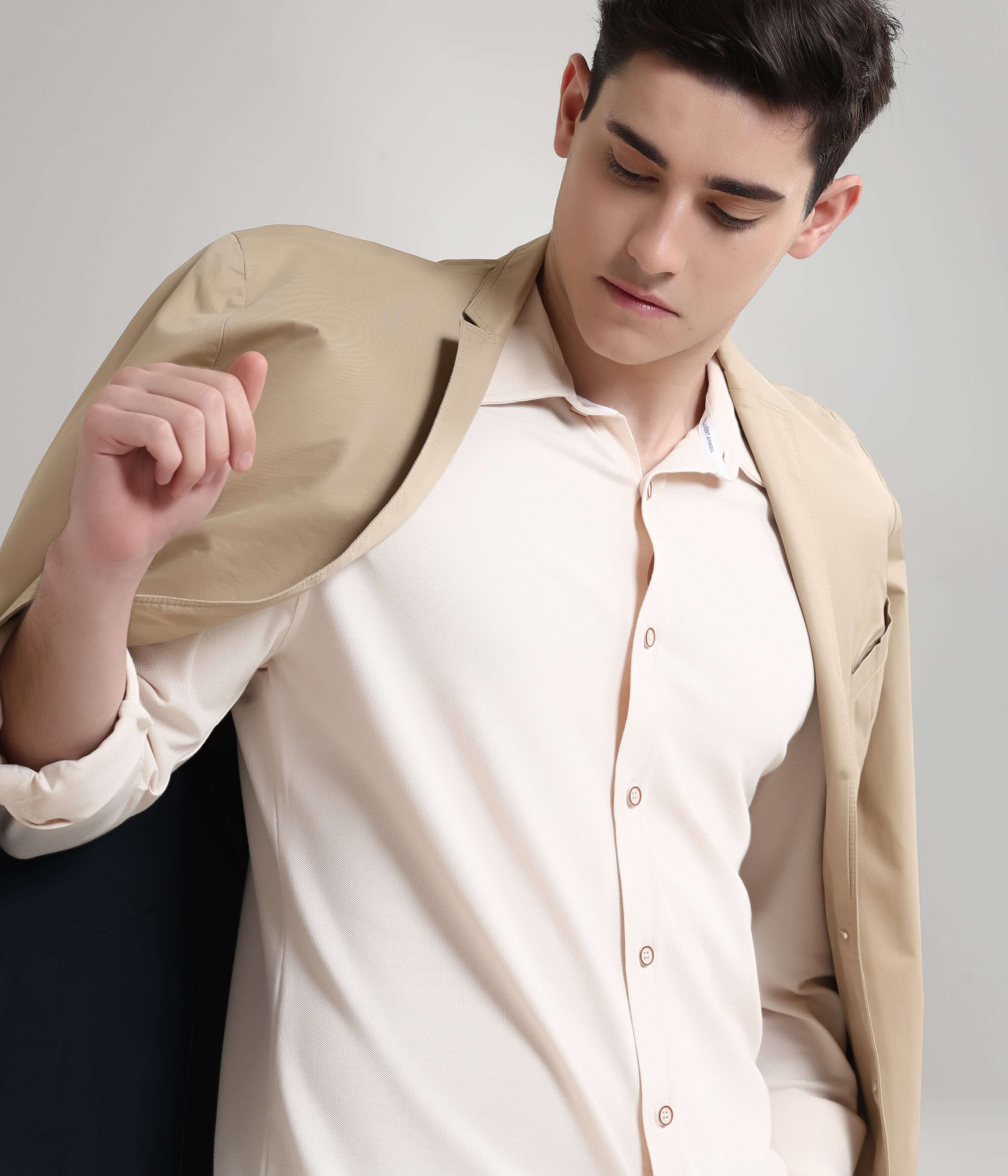 Man wearing Dusky Beige Knitted Turms Stretchable Shirt, showcasing premium menswear style with anti-stain and anti-odour features.