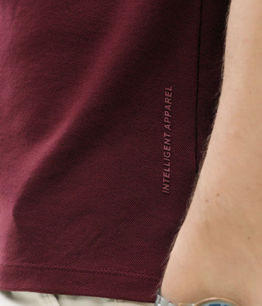 Close-up of maroon Turms Intelligent Apparel polo shirt with anti-stain and anti-odor features in premium cotton and tailored fit.