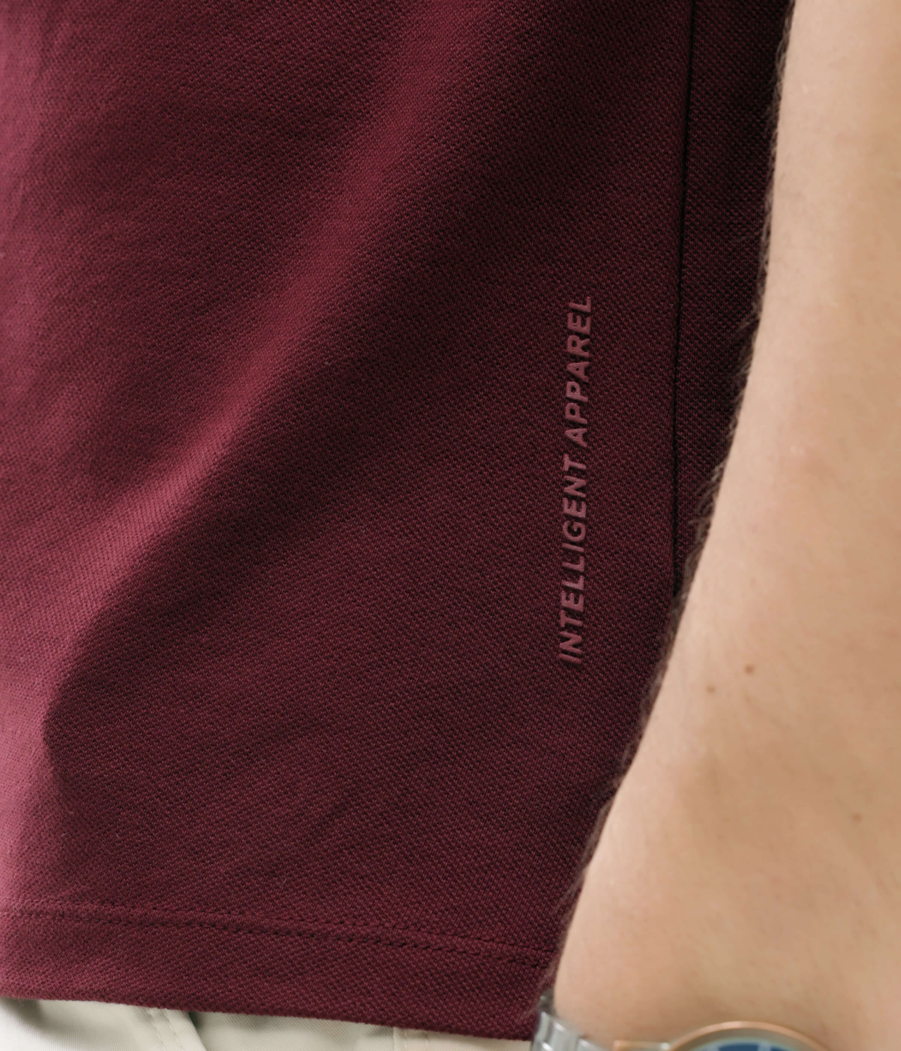 Close-up of maroon Turms Intelligent Apparel polo shirt with anti-stain and anti-odor features in premium cotton and tailored fit.