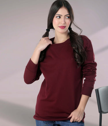 Model wearing a burgundy Turms Intelligent Sweatshirt, showcasing its stylish design and comfortable fit. Best women's hoodie for travel wear.