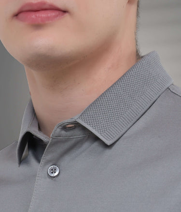 Close-up of a tailored grey polo t-shirt collar, showcasing its premium fabric and texture, emphasizing stain and odor resistance.