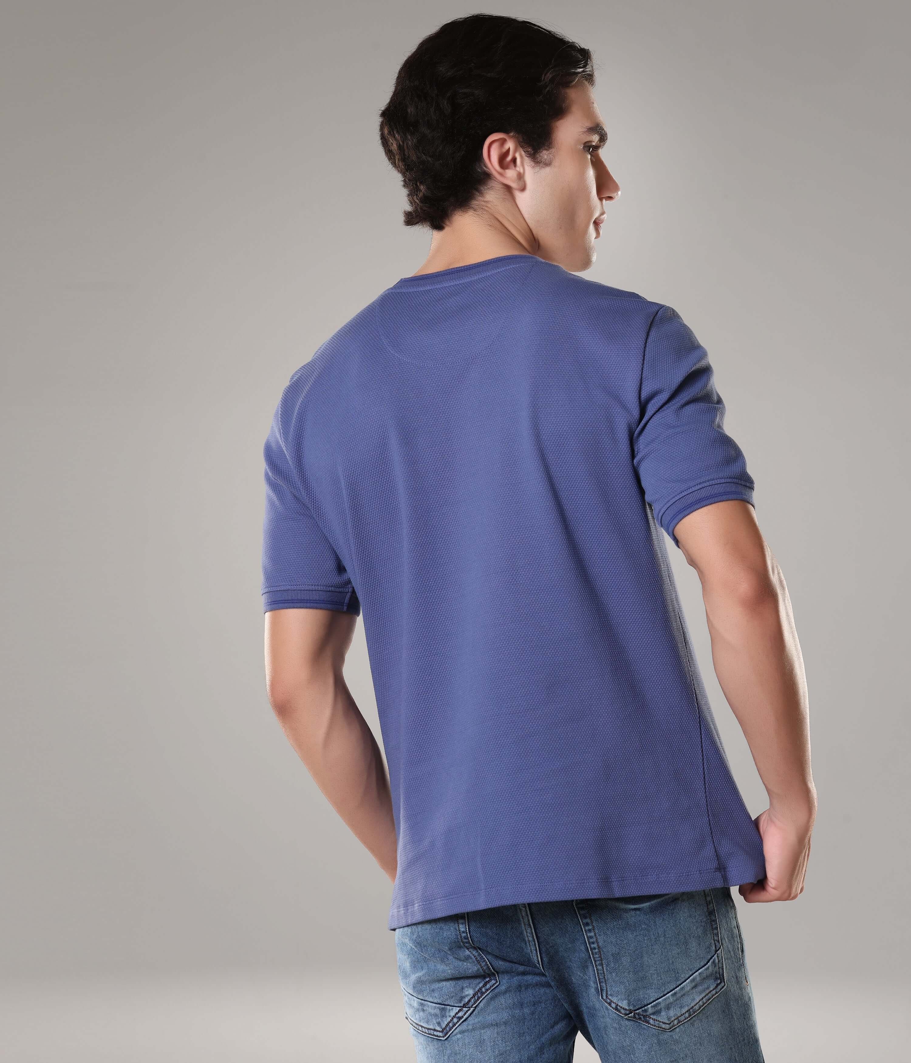 Man wearing Blooming Orchid Coolant Round-Neck Turms T-shirt in blue, made from 95% premium cotton and 5% spandex, showcasing back view.