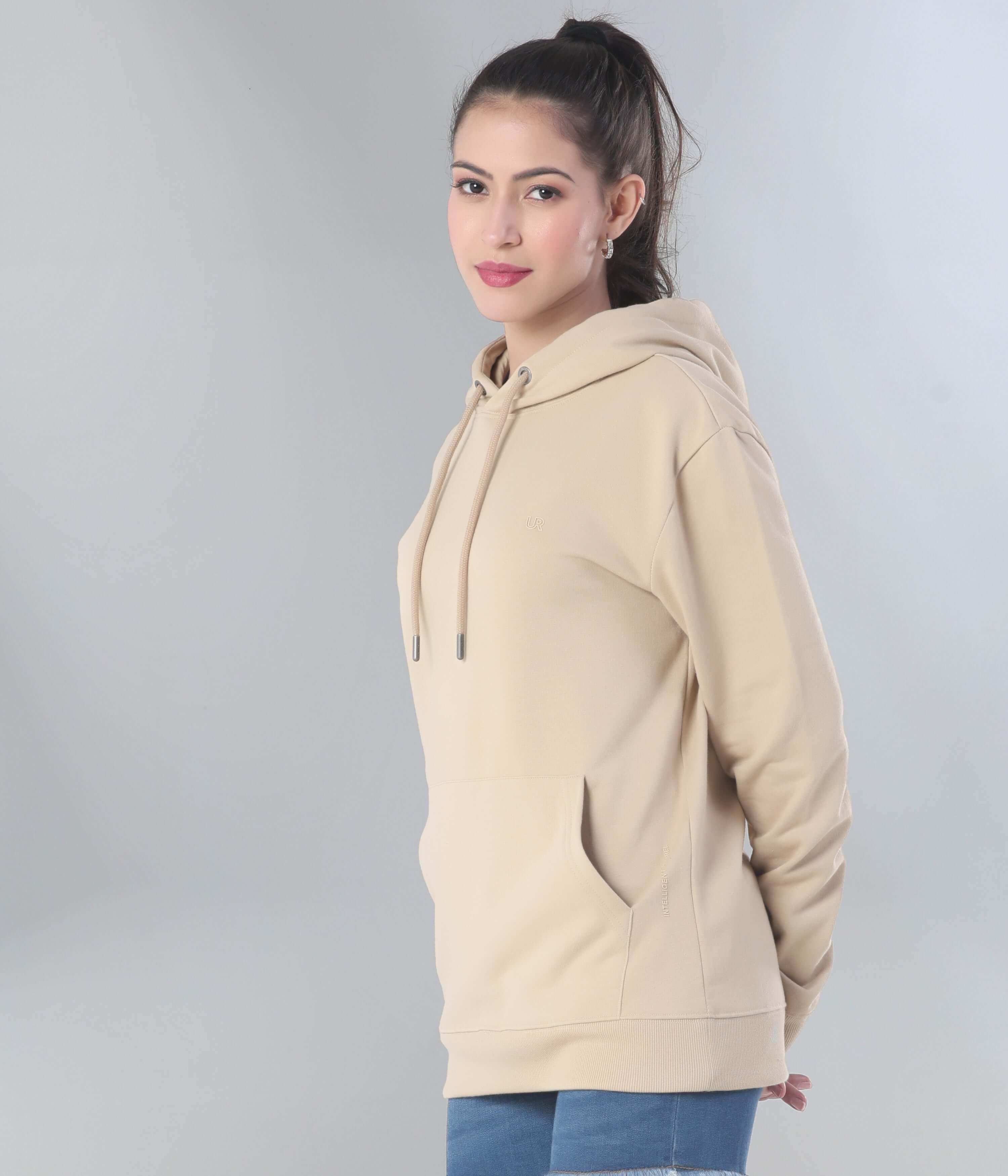 Woman in beige Turms Intelligent Hooded Sweatshirt, showcasing style and comfort in a modern everyday wear design.