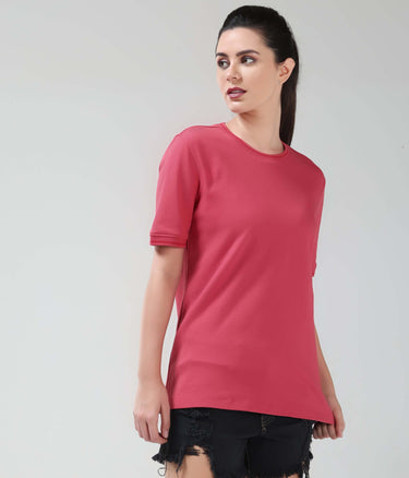 Woman wearing Regal Pink CoolTech T-shirt by Turms Intelligent Apparel with honeycomb anti-odour fabric, perfect for staying cool and comfortable.