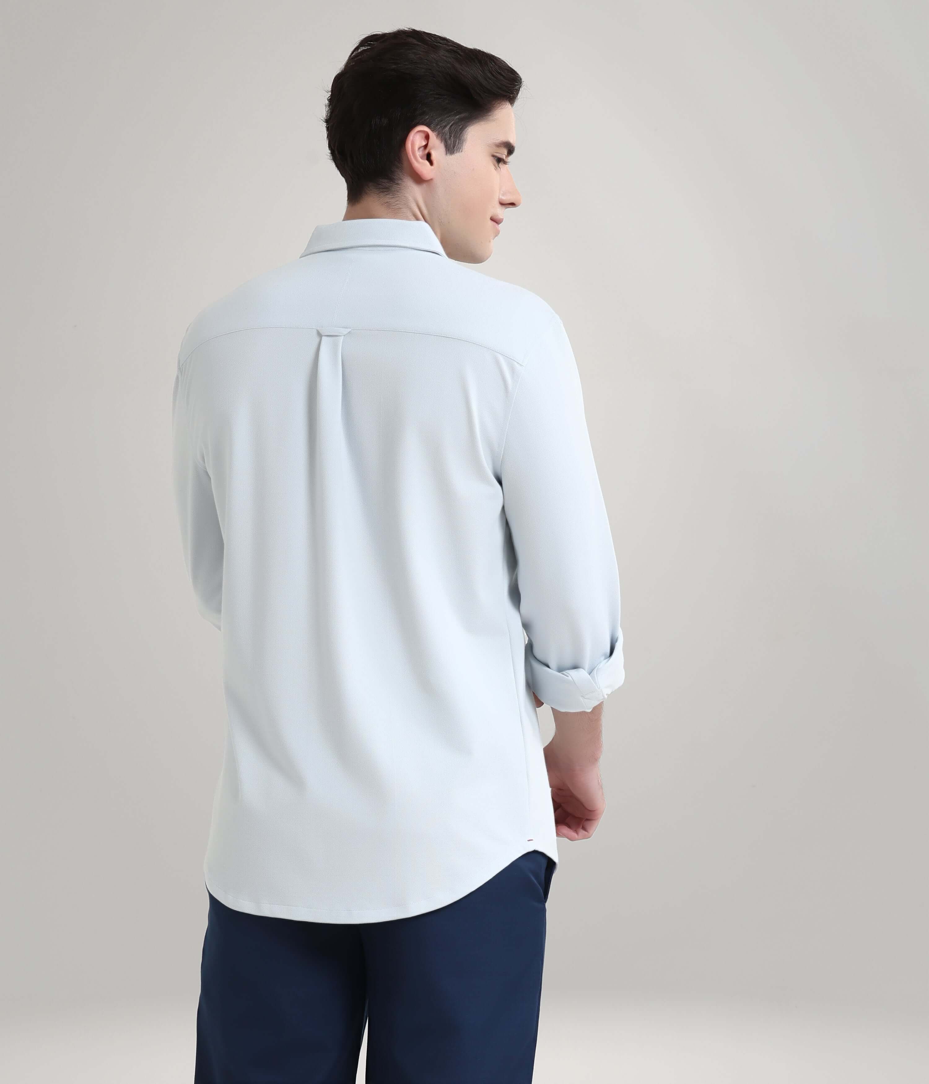 Man wearing Ethereal Blue Knitted Turms Shirt, featuring anti-stain and anti-odor technology, premium menswear style.