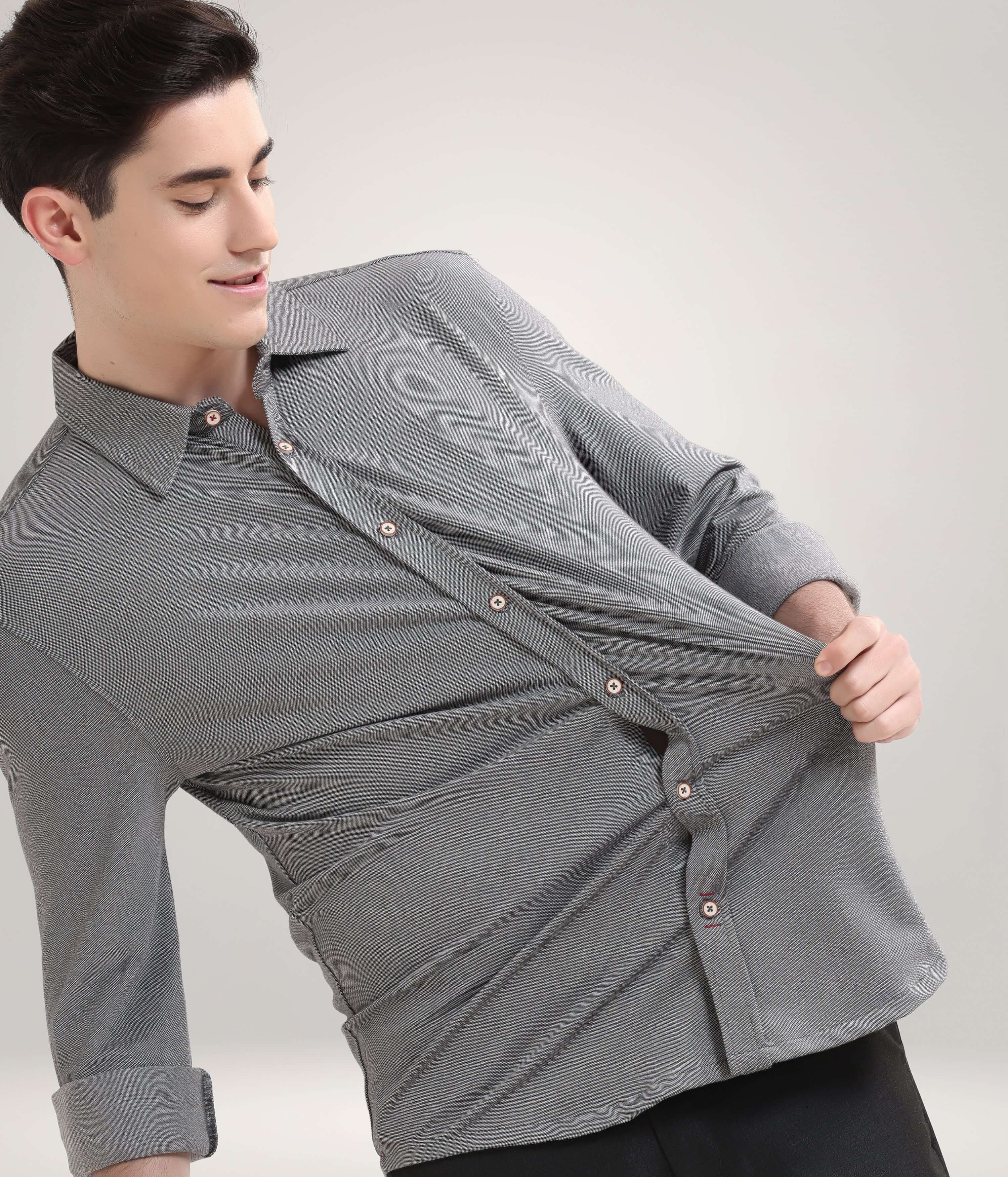 Man wearing Stormy Charcoal Knitted Turms Stretchable Shirt, showcasing anti-stain and anti-odor features in premium menswear.