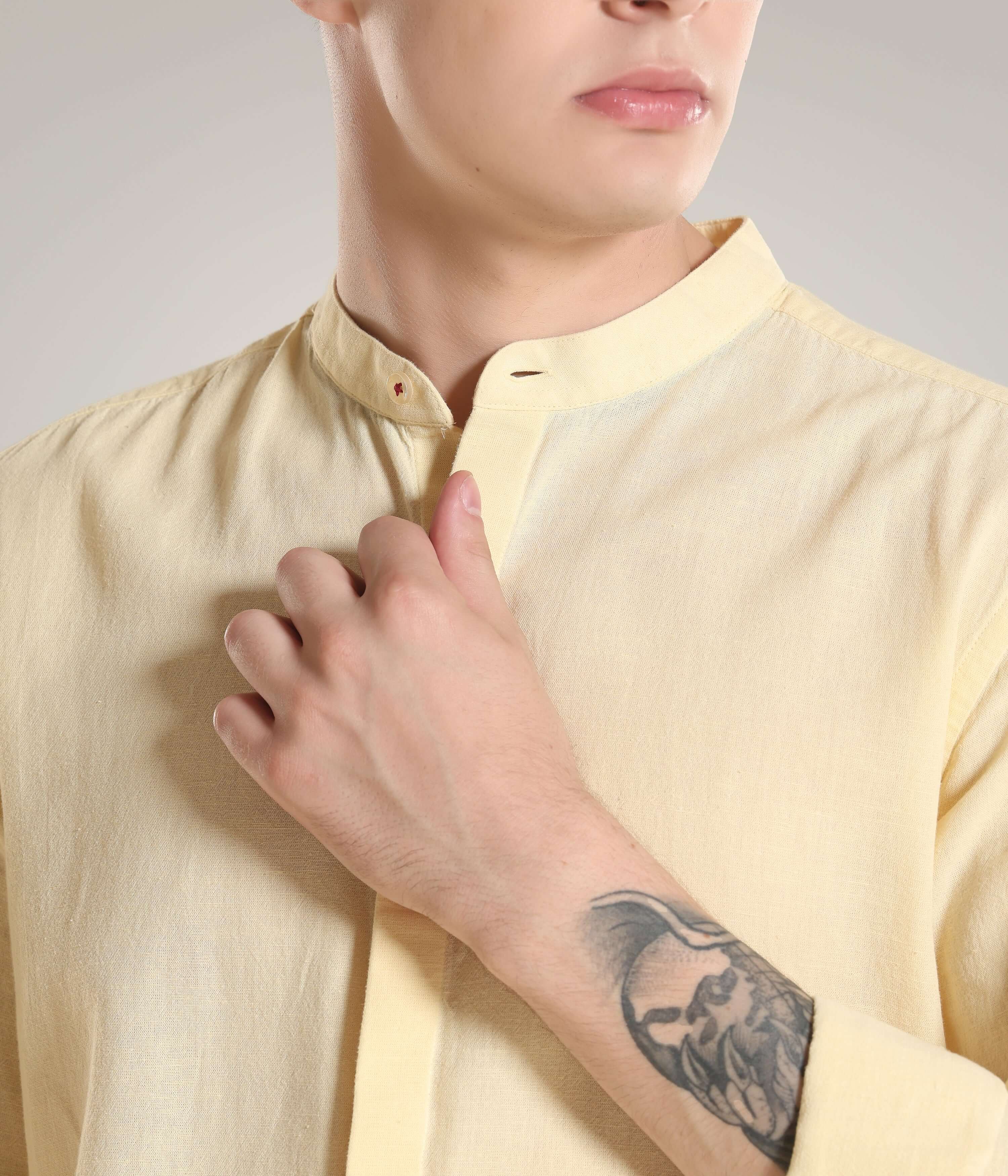 Man wearing pastel yellow cotton-linen Turms shirt with premium mandarin collar showcasing the meticulous stitching and design.