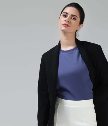 Woman wearing purple Blooming Orchid COOLTECH T-Shirt with black blazer and white skirt, featuring Turms intelligent apparel.