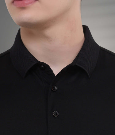 Close-up of a black polo shirt collar, showcasing tailored fit and buttons, ideal for water and stain-resistant wear.