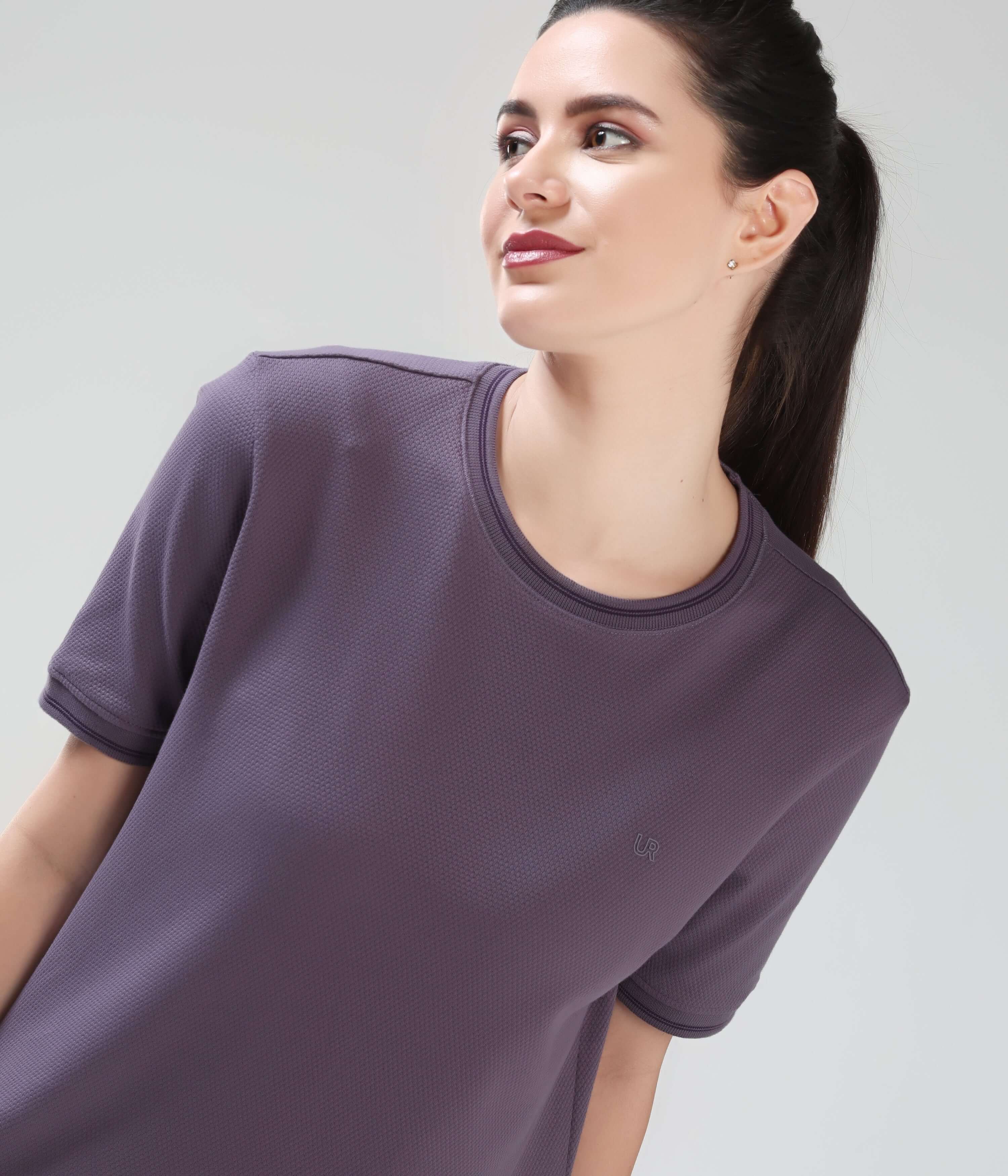 Woman wearing Mulberry Dynasty COOLTECH T-shirt in new colour by Turms, featuring tailored fit, anti odour honeycomb fabric, and intelligent apparel technology.