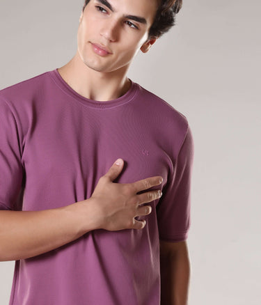 Man wearing Dusty Rose Turms T-shirt, showcasing tailored fit and crew neck, made from premium cotton and Spandex, featuring anti-microbial properties