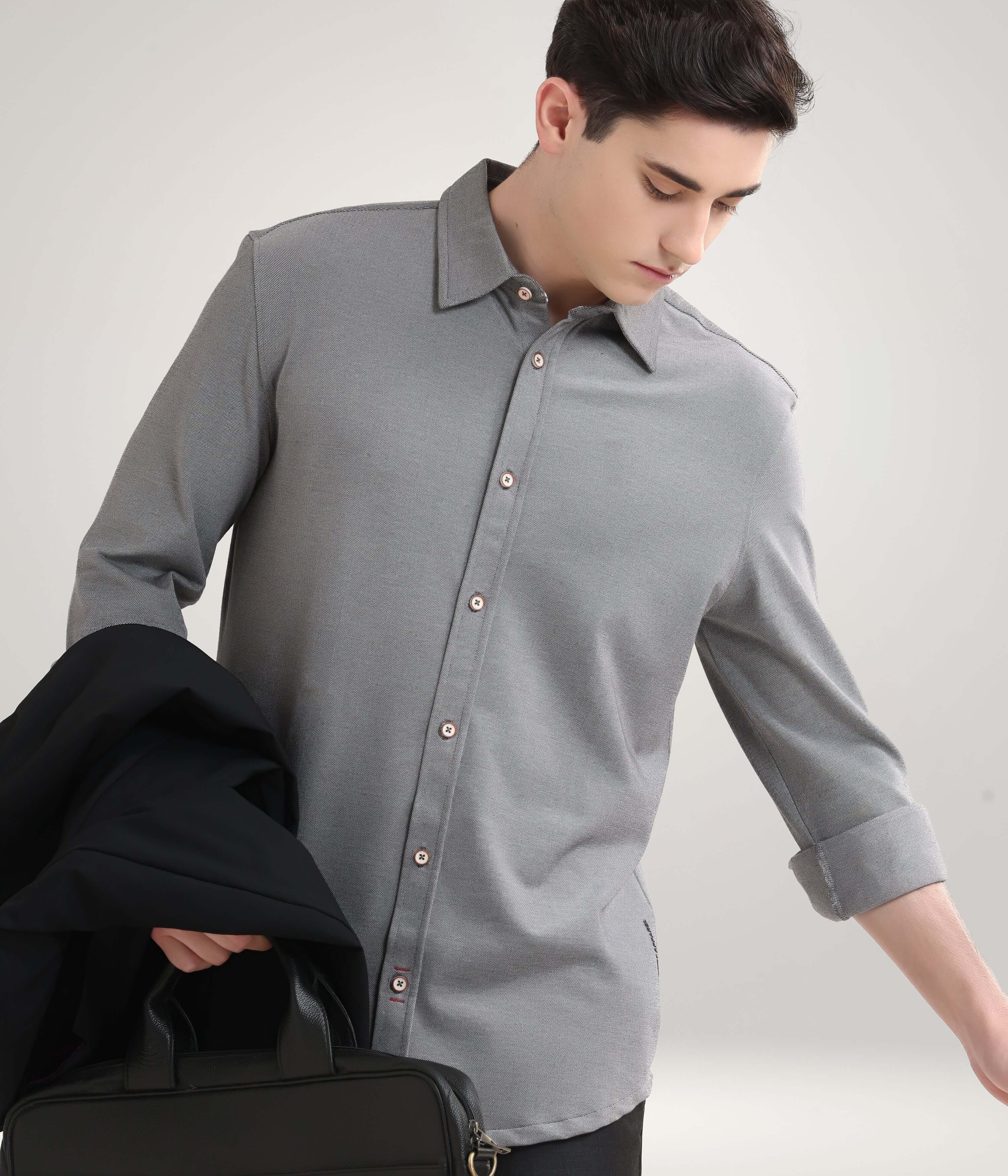 Man wearing Stormy Charcoal knitted shirt, showcasing premium menswear style with anti-stain, anti-odor features.