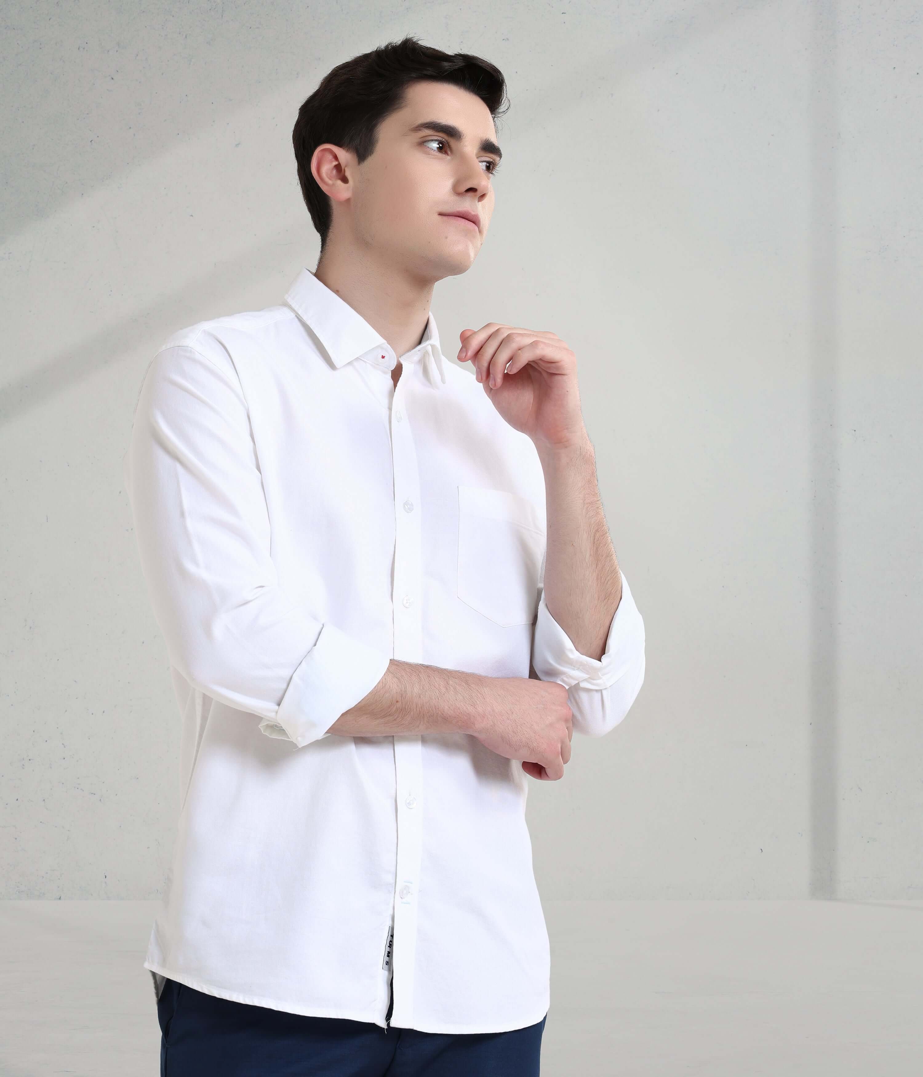 Young man in a stylish white Oxford shirt, showcasing the elegance of Toscana Lux's anti-stain and anti-odour features.