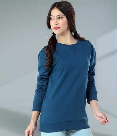 Model wearing a blue Turms Intelligent Sweatshirt, showcasing style and comfort in casual wear. Best women's hoodie for travel.