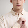 Man wearing a Dessert Beige Oxford Turms knitted stripe shirt with premium concealed button collar, anti-stain and anti-odour features.