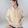 Woman wearing a beige Turms Intelligent Hooded Sweatshirt, showcasing style, comfort, and water-resistant features.