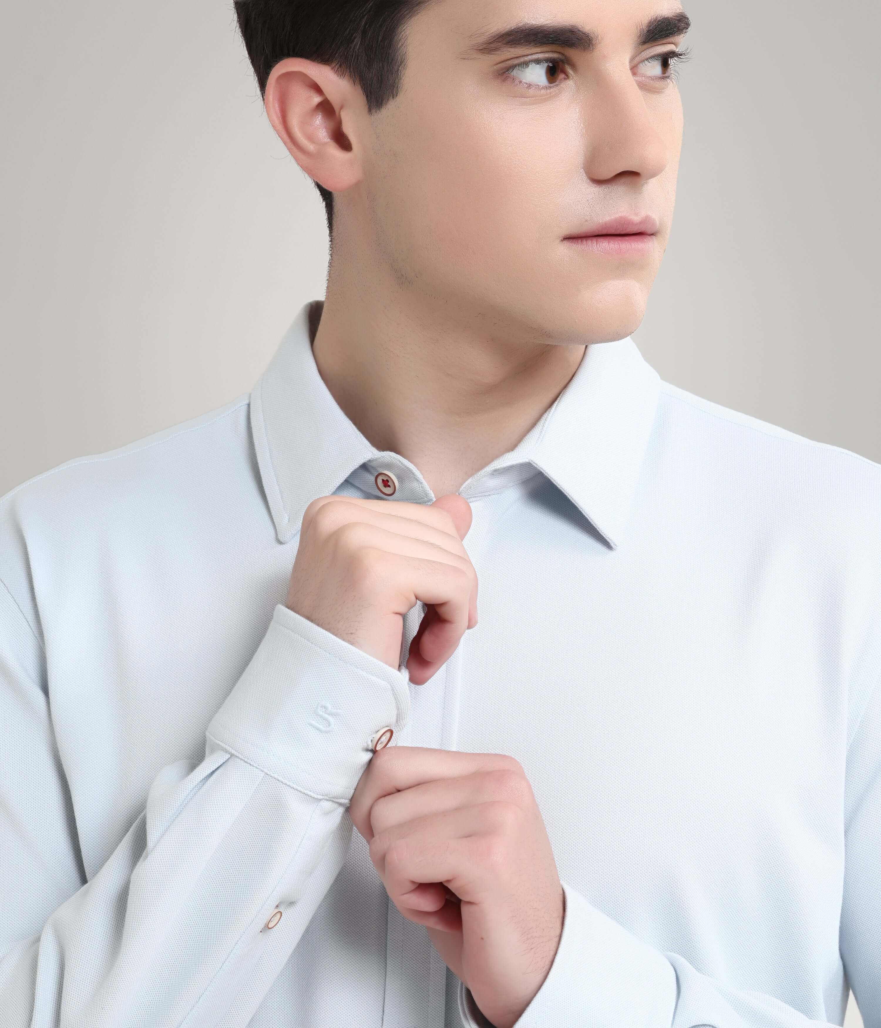 Man wearing Ethereal Blue Knitted Turms Stretchable Shirt, showcasing premium menswear with anti-stain, anti-odour features.