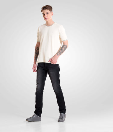 Man wearing Black Sparrow high-performance denim pants showcasing modern-style menswear from Turms Intelligent Apparel