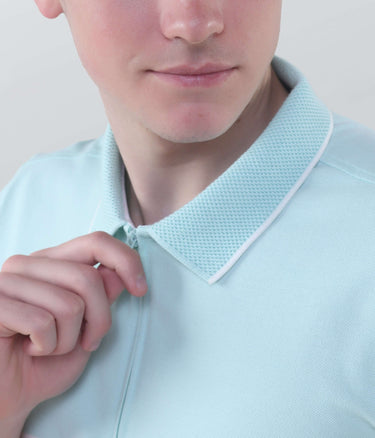 Close-up of a man in a blue polo shirt with a zipped collar, showcasing the breathable fabric and stylish design.