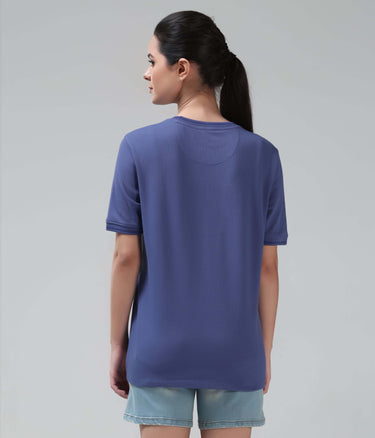Woman wearing Blooming Orchid Cooltech T-shirt by Turms, featuring anti-odour honeycomb fabric and intelligent apparel technology in new colour.
