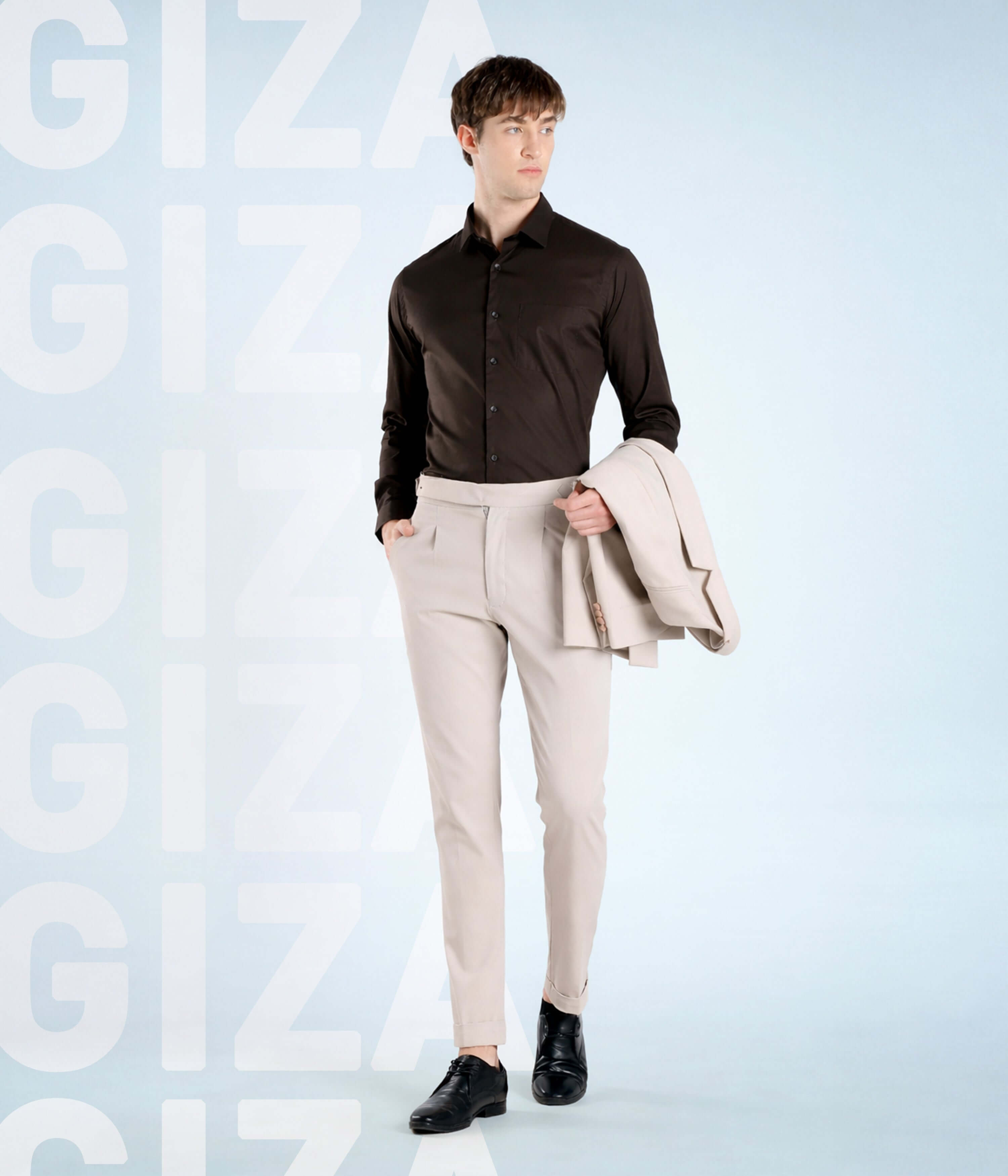 Olive Empire: Model in Giza cotton shirt and light trousers, showcasing Turms Intelligent apparel. Premium quality.