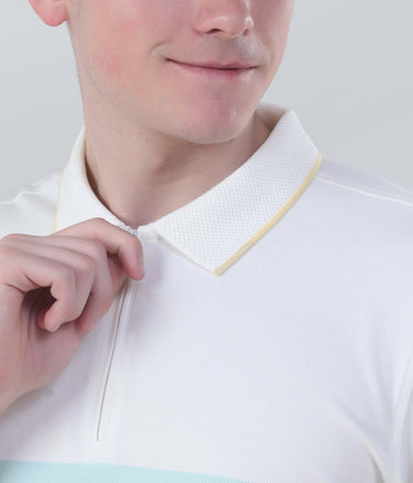 Close-up of a man adjusting the collar of a stylish Vanilla Cream polo shirt with a zipper.