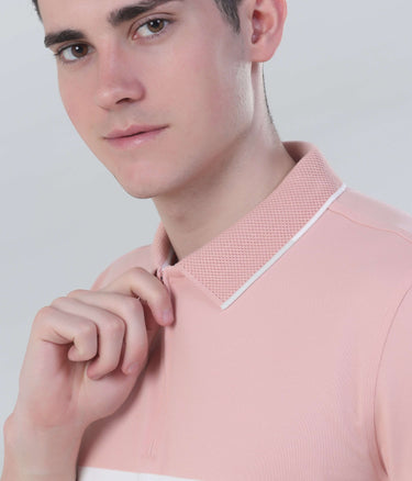 Model wearing a pink zipped polo shirt, showcasing style and comfort with a modern collar design.