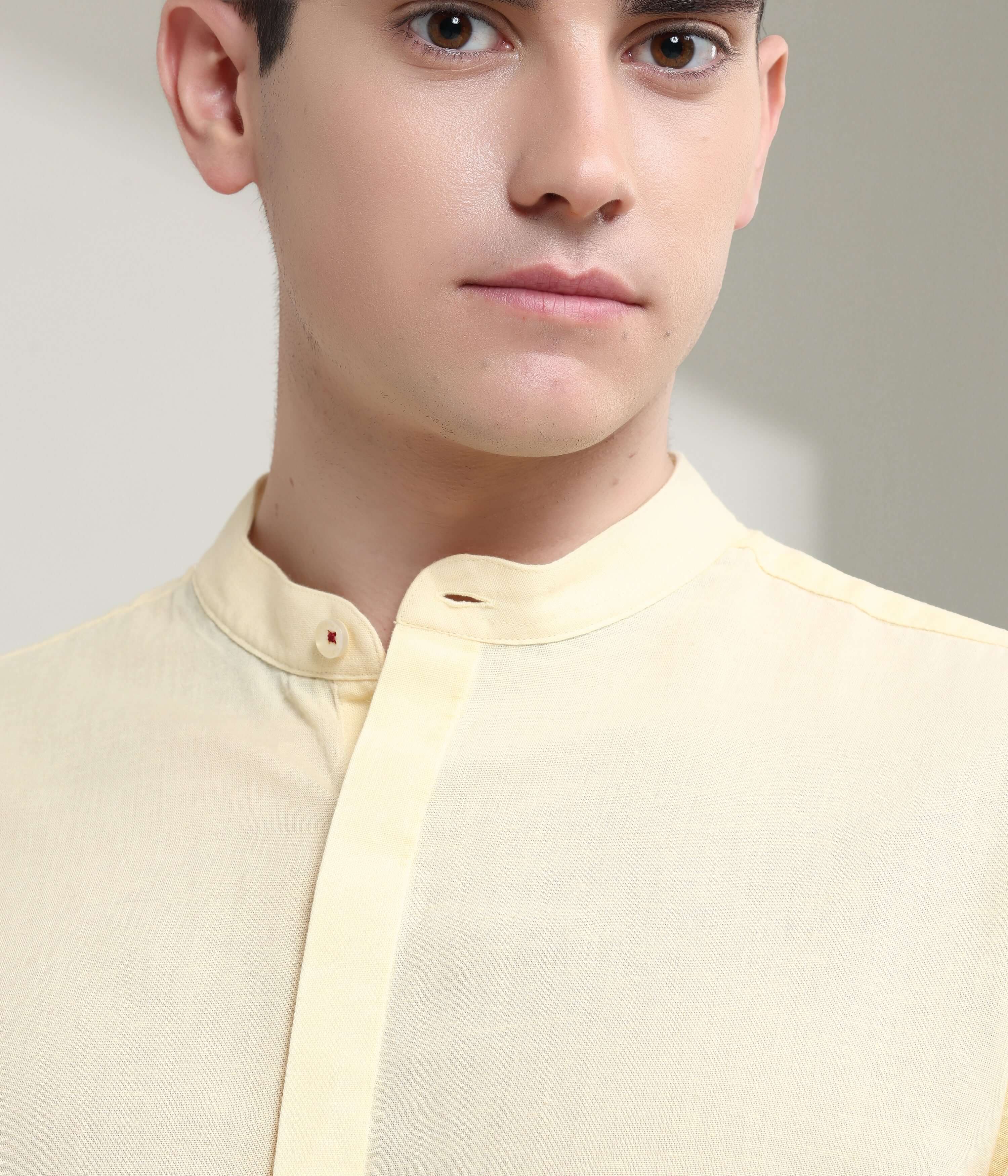 Pastel yellow linen shirt with mandarin collar showcasing Turms intelligent apparel, featuring anti-stain and anti-odour technology.