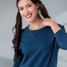 Model wearing a blue Turms Intelligent Sweatshirt, showcasing its stylish V-notch neckline and comfortable fit.
