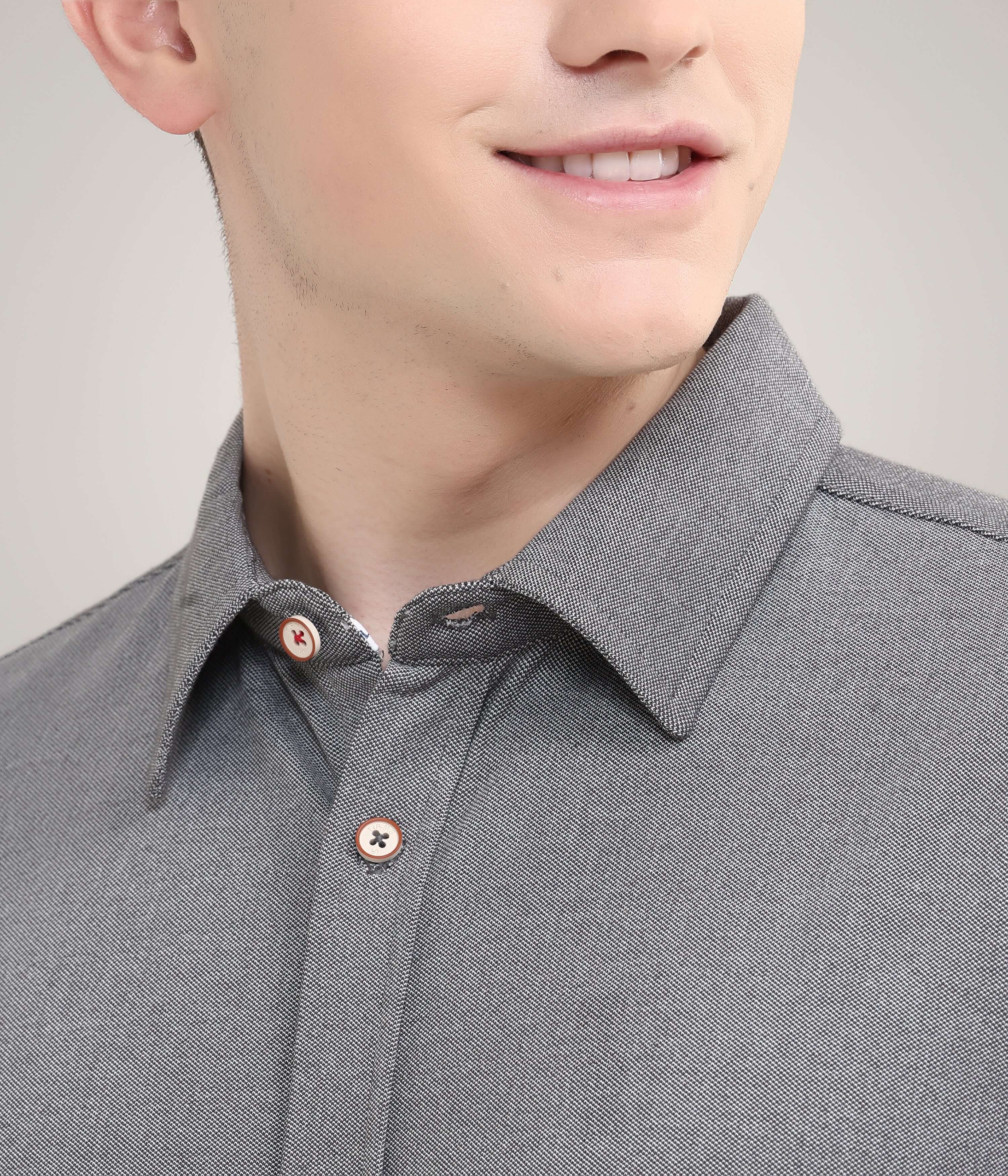 Close-up of a man wearing a Stormy Charcoal knitted stretchable shirt, showcasing premium menswear with anti-odor and anti-stain features.