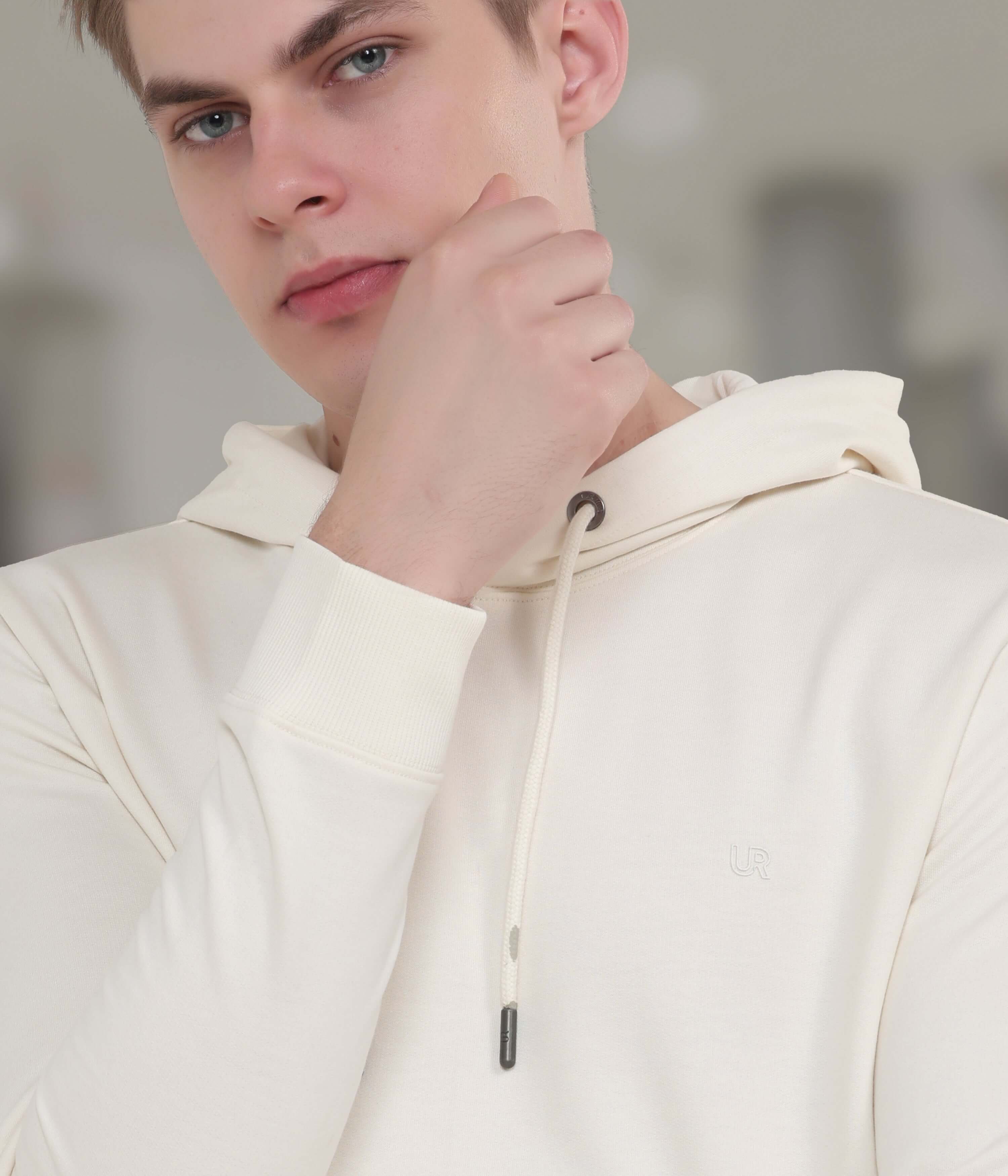 Stylish man wearing a cream Snow Runner hoodie, showcasing its comfort and premium fabric. Ideal for everyday wear.