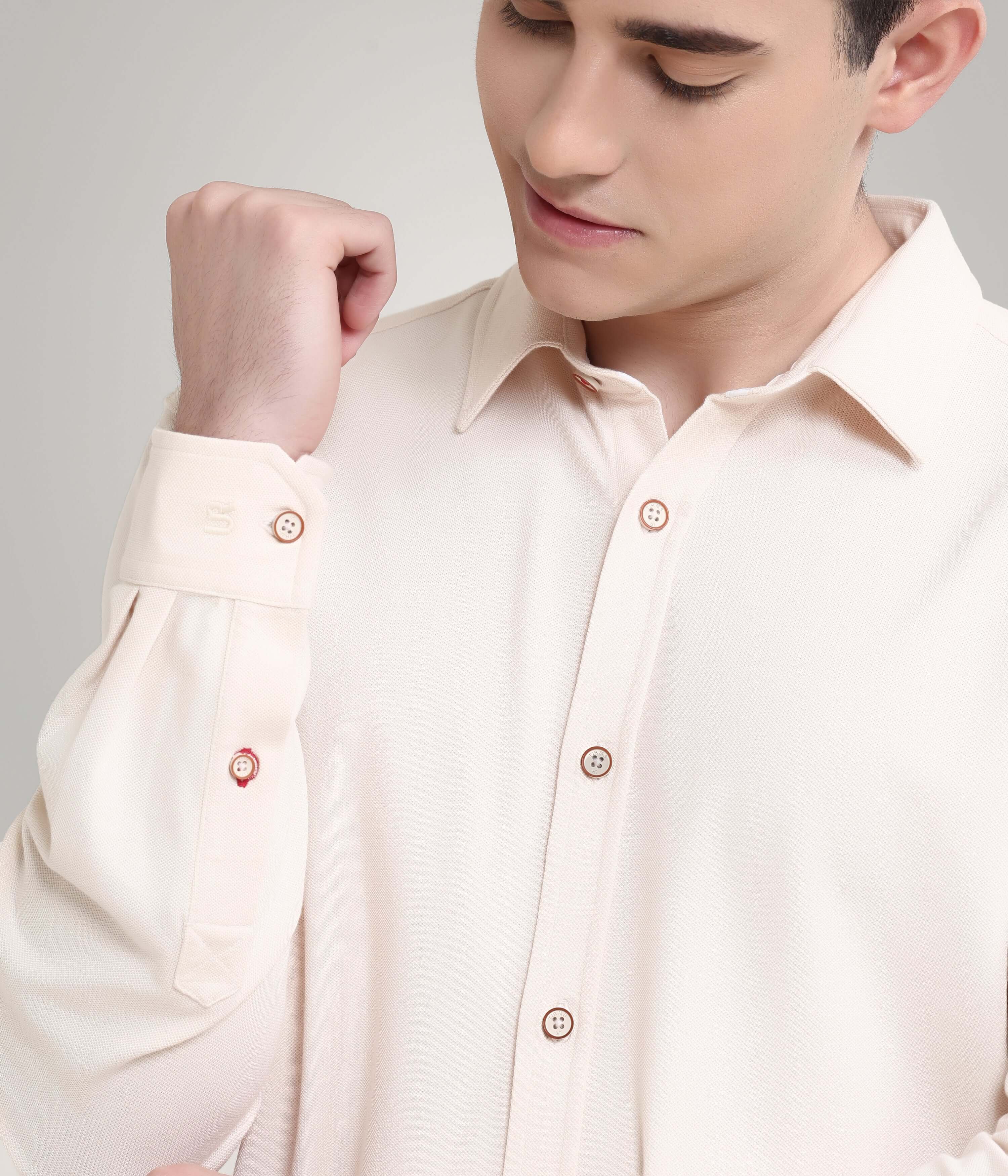 Man wearing dusky beige knitted stretchable shirt, featuring anti-stain and anti-odour properties, premium menswear shirt.