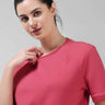 Woman wearing a Regal Pink COOLTECH T-shirt by TURMS Intelligent Apparel, featuring anti-odour honeycomb fabric and tailored fit.