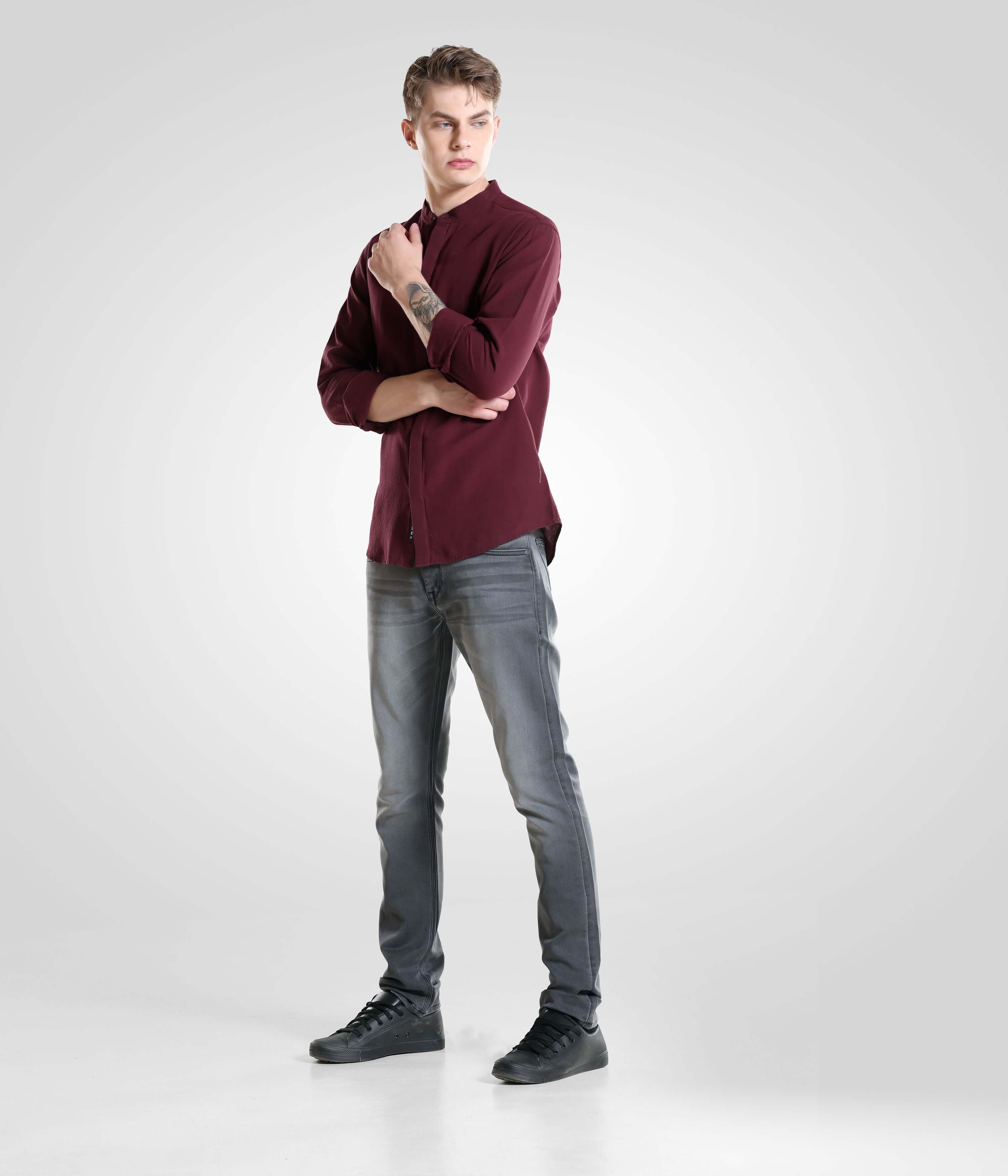 Man wearing Grey Monk high-performance denim pants and a burgundy shirt showing a stylish and comfortable menswear look