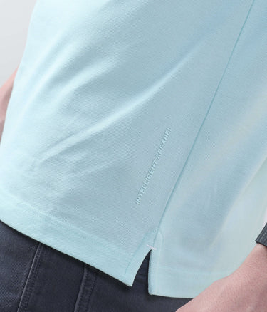 Close-up of blue origami polo shirt showcasing the intelligent apparel detail and stylish side split.