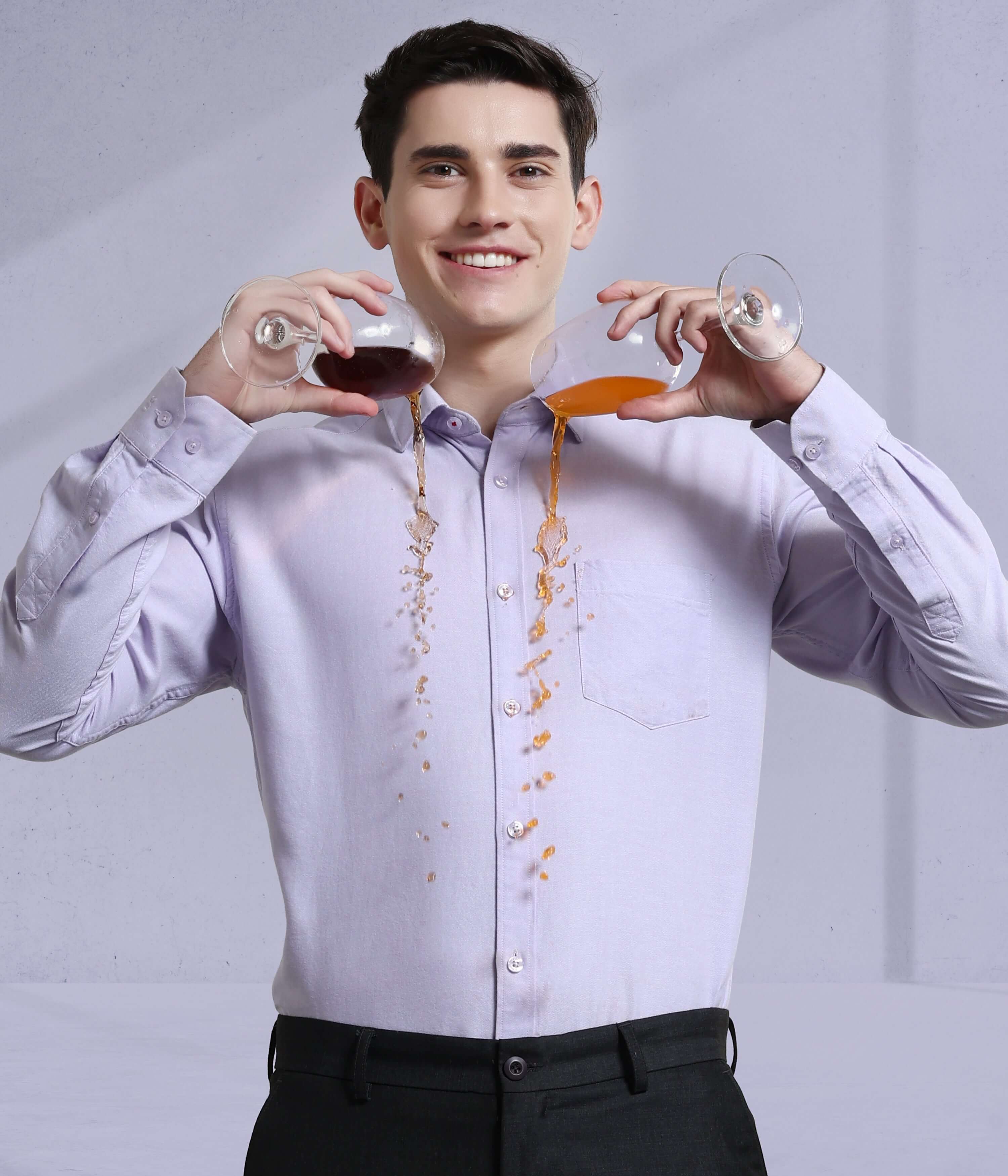 Man wearing Lavender Haven Oxford Turms shirt showcasing its anti-stain and waterproof features with spilled drinks.