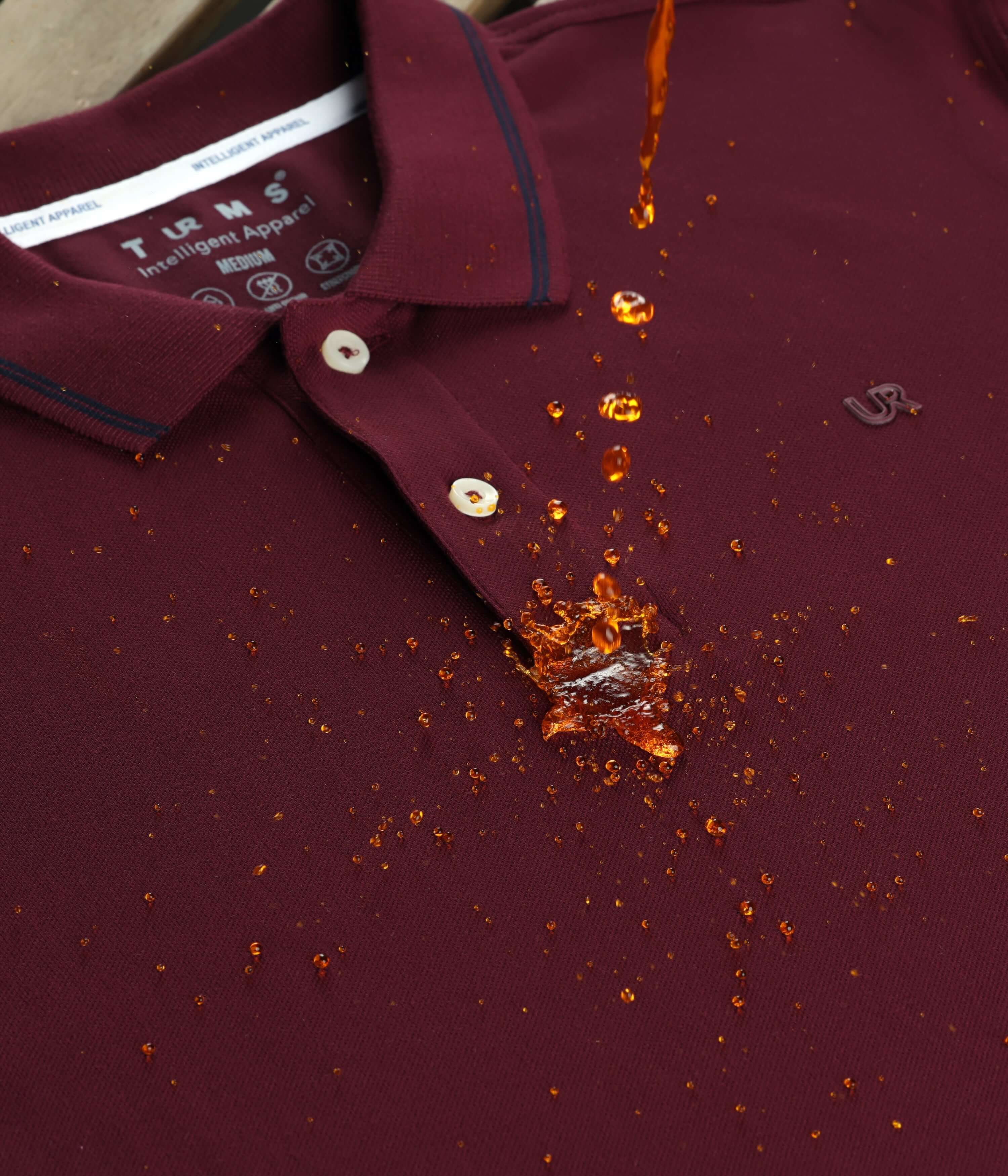 Burgundy stain-proof Turms Polo T-shirt repelling a liquid spill, showcasing premium cotton and lycra fabric, anti-stain, anti-odor features.