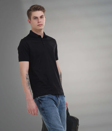 Black mercerized polo t-shirt with anti-stain and anti-odor features, worn by a young man in stylish casual attire.