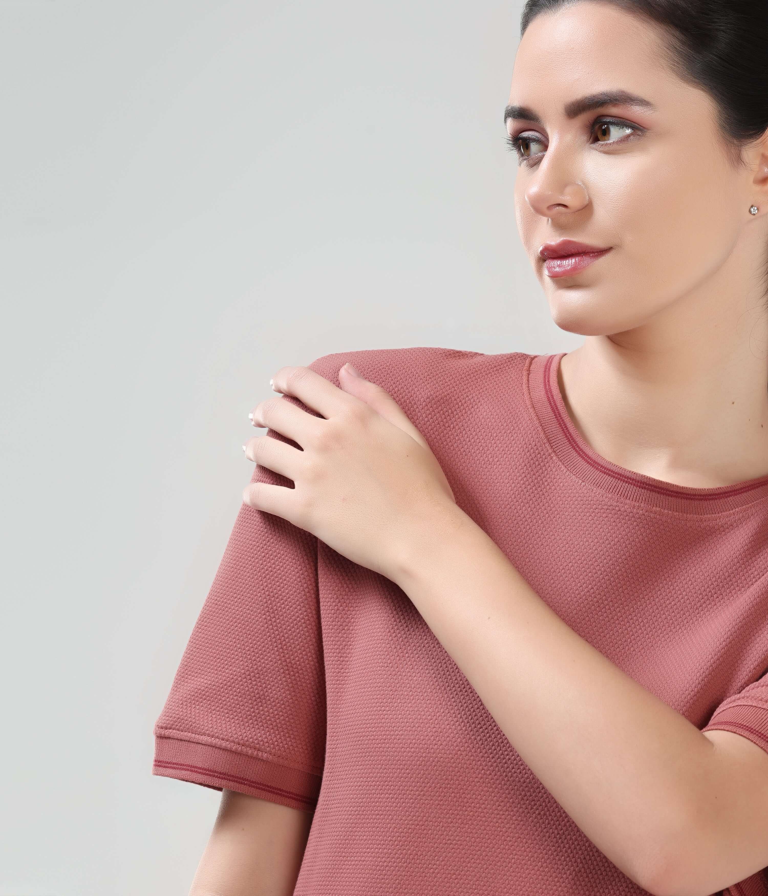 Woman wearing Vivid Brick COOLTECH T-shirt with round neck made from honeycomb fabric by TURMS, featuring anti-odour and intelligent apparel technology