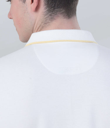Back view of a man wearing a white polo shirt with a yellow collar, highlighting the stylish design and quality craftsmanship.