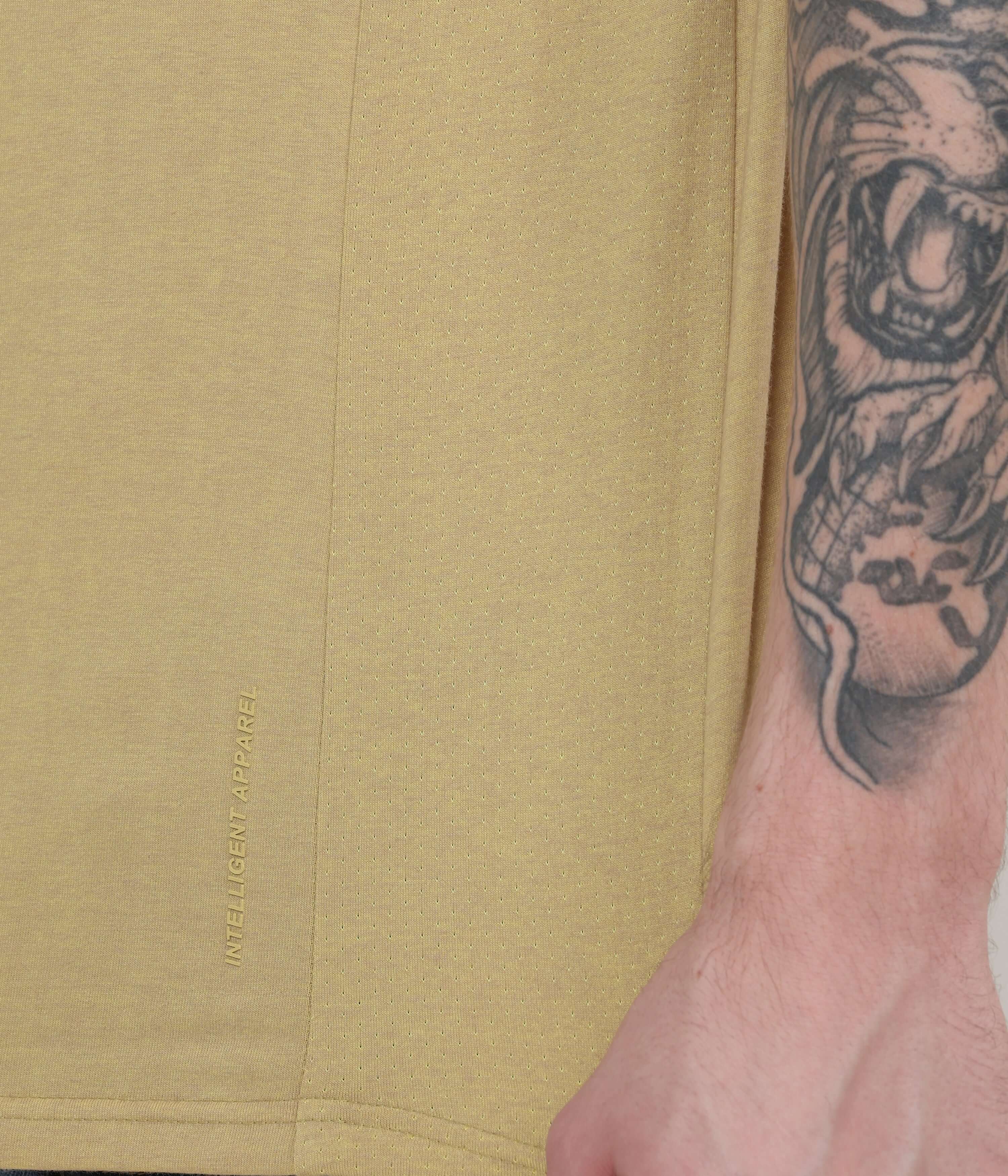 Close-up of Mountain Beige Turms Intelligent Henley T-Shirt showcasing logo and fabric texture, highlighting anti-odour moisture control.