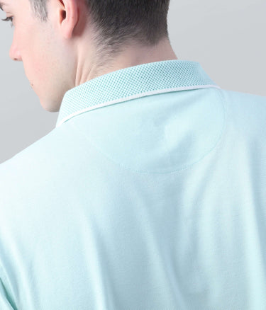 Back view of a mint green polo shirt showcasing breathable mesh collar design and premium cotton fabric.