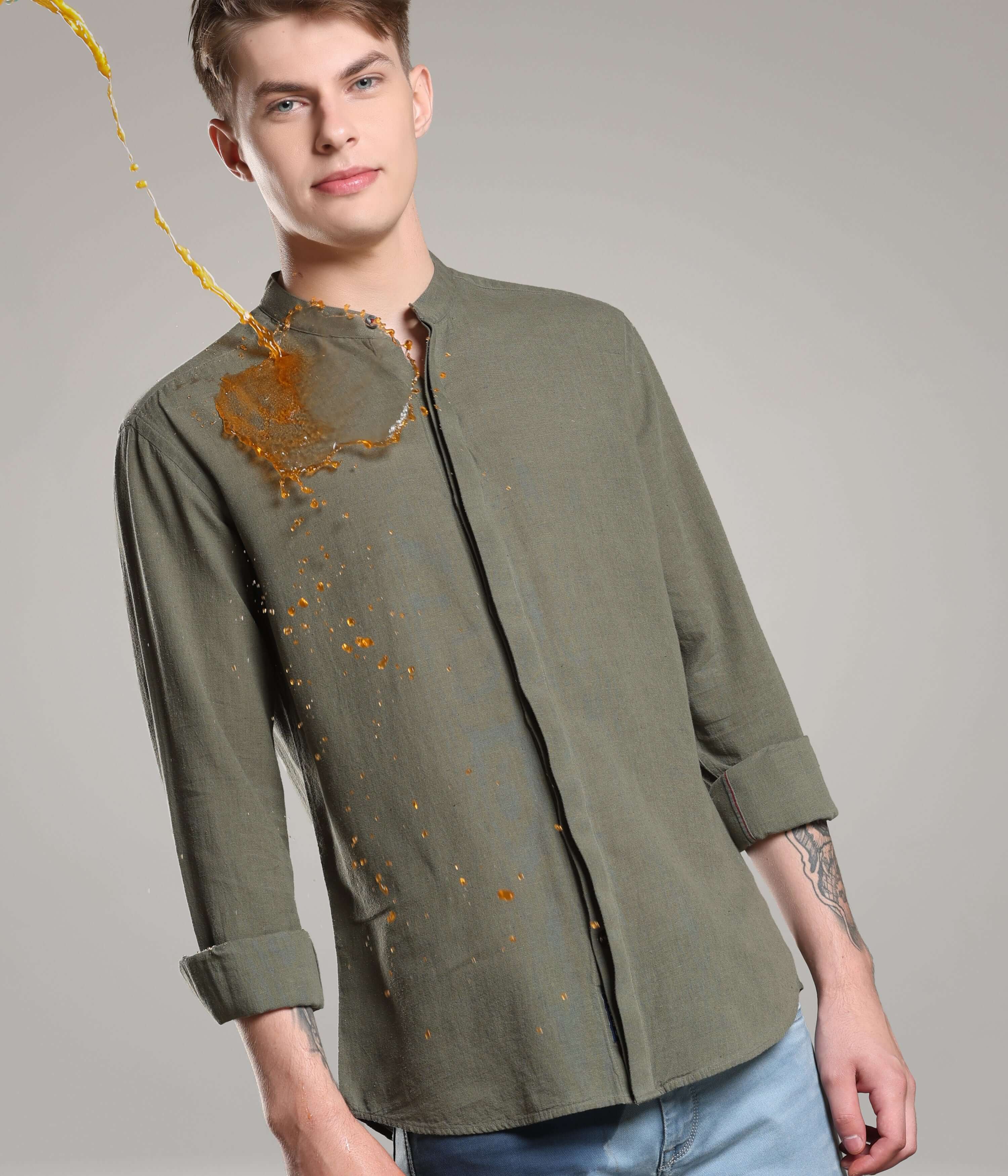 Man wearing Lichen Green Cotton/Linen Turms shirt demonstrating antistain property, premium clothing with CoolTech and anti-odour features.